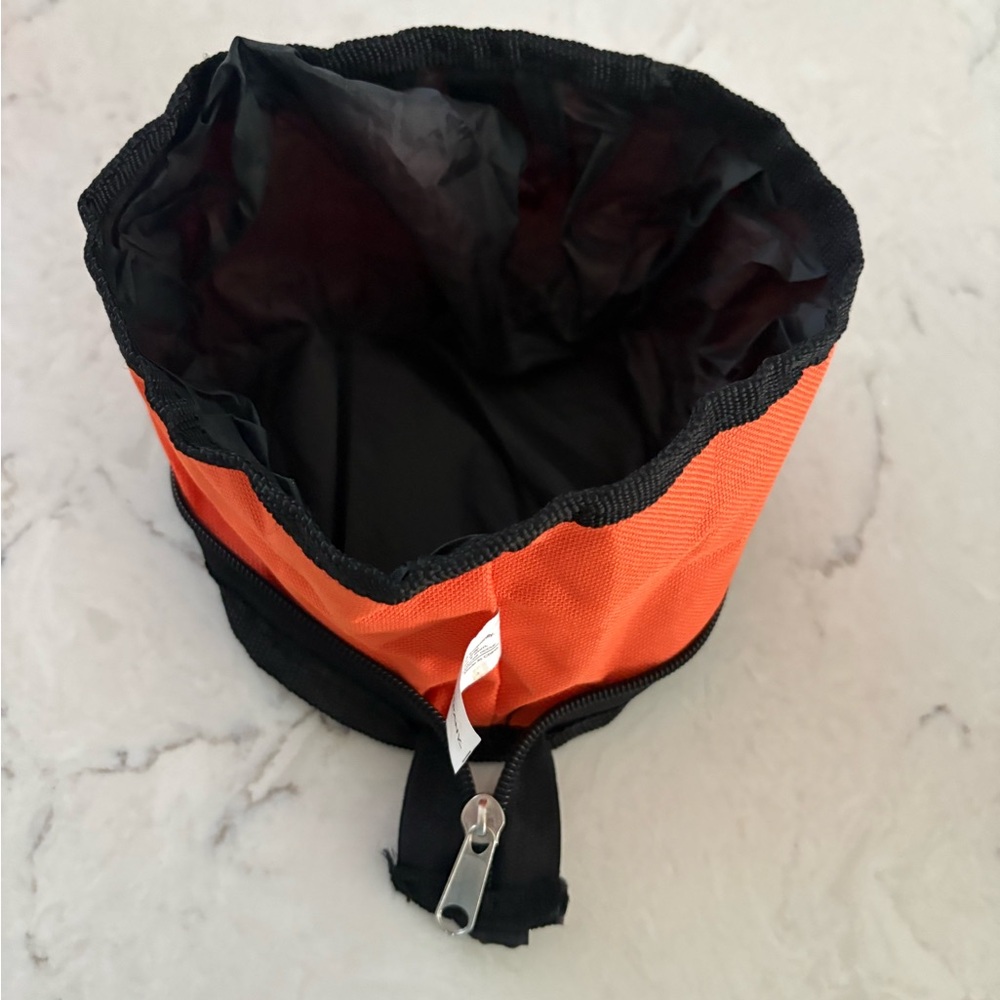 Dog & Company, collapsible portable dog bowl. Clip onto backpack or belt loop.